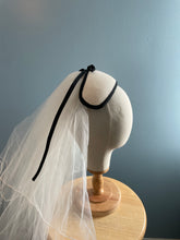 White velour felt bandeau with black bow headpiece and veil