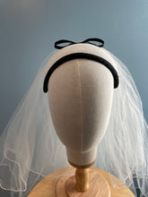 White velour felt bandeau with black bow headpiece and veil